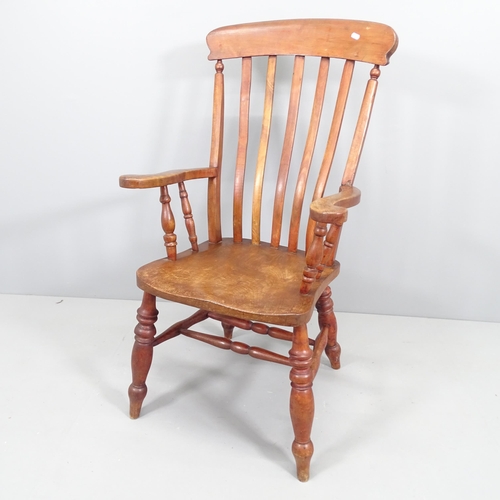 2159 - An antique elm-seated Windsor kitchen armchair.