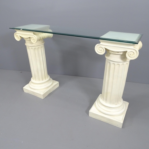 2162 - A glass top console table with 2 composite columns. Overall: 130x84x35, columns each: 35x82cm.