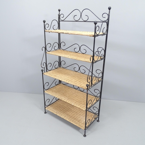 2171 - An ornate wrought iron folding stand with 5 fixed wicker shelves. 63x122x33cm.