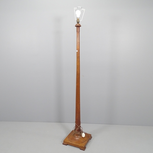 2181 - A turned stained pine standard lamp on pedestal base. Height 160cm