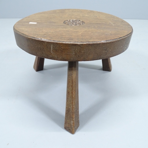 2190 - A carved oak circular stool/low occasional table on tripod base, with central carved rose. Signed Ja... 