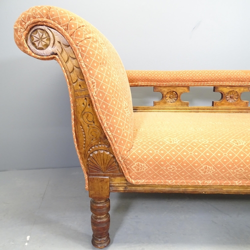 2530 - An Arts and Crafts oak and upholstered chaise longue, with carved decoration.170x70x64cm