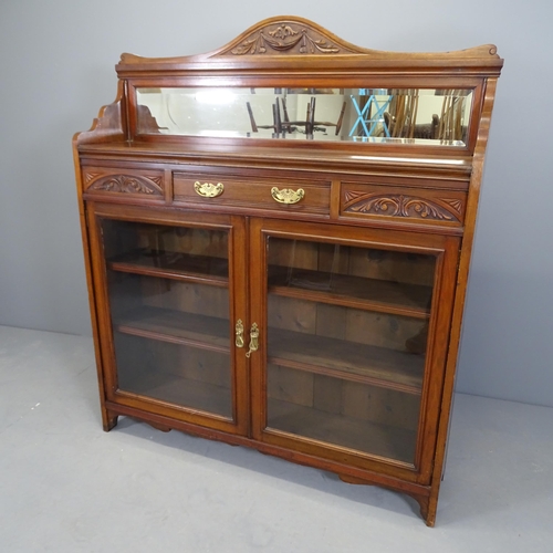 2533 - A Victorian Arts & Crafts two door bookcase, with raised mirrored back, single frieze drawer and thr... 