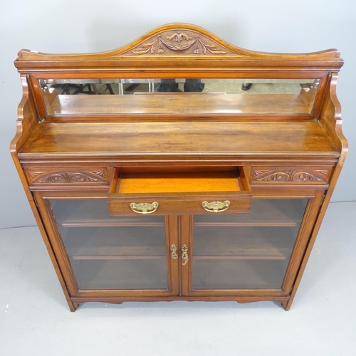 2533 - A Victorian Arts & Crafts two door bookcase, with raised mirrored back, single frieze drawer and thr... 