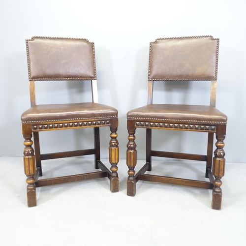 2536 - A pair of carved oak and leather upholstered hall chairs.