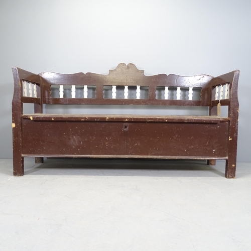 2538 - An antique painted pine settle, the lifting seat revealing a storage compartment. 185x94x60cm