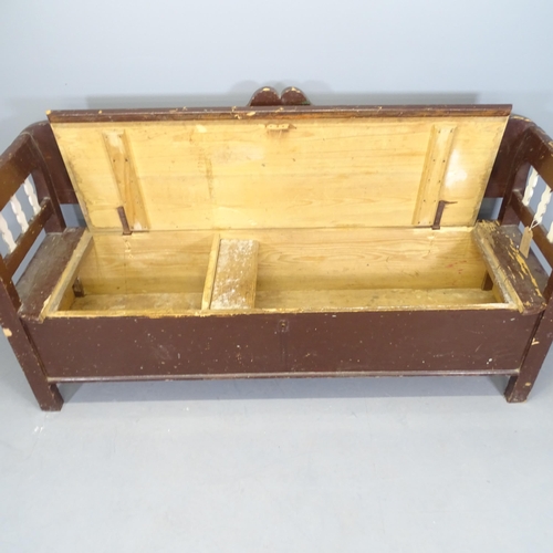 2538 - An antique painted pine settle, the lifting seat revealing a storage compartment. 185x94x60cm