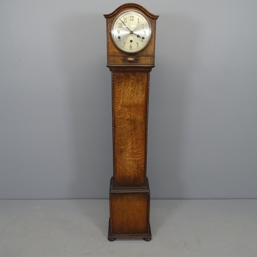 2540 - An early 20th century oak cased grandmother clock, with pendulum and key. 25x130x20cm.