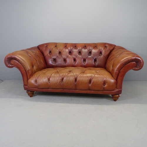 2575 - A button back leather upholstered Chesterfield sofa with rollover arms. 205x83x100cm