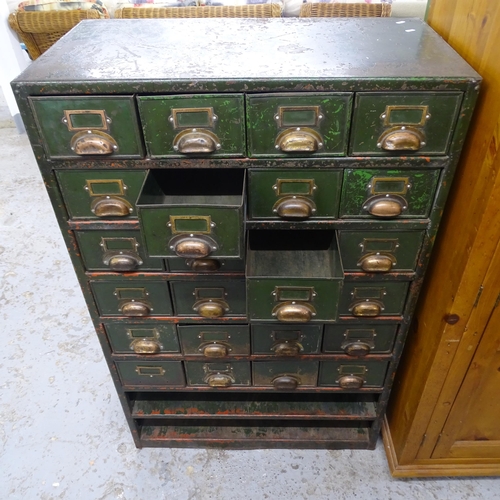 2580 - A vintage painted metal bank of filing drawers. 92x143x50cm.