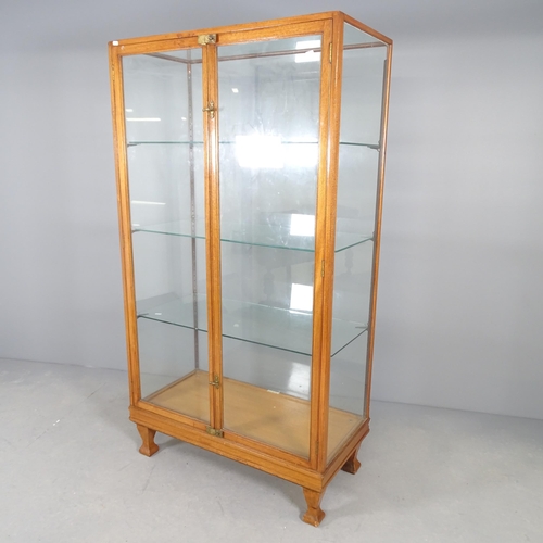 2581 - An antique oak framed glazed shop display cabinet by F. Maund and E. Berg (showcases) Ltd. of London... 