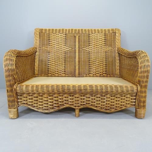 2584 - A modern wicker three-piece conservatory suite, comprising a two-seater sofa, 134x95x100cm, and two ... 