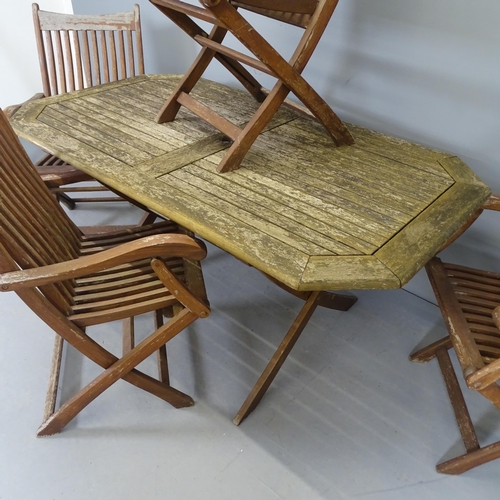 2587 - A weathered teak folding garden table, 150x71x86cm, and four teak folding chairs, with label for Sca... 