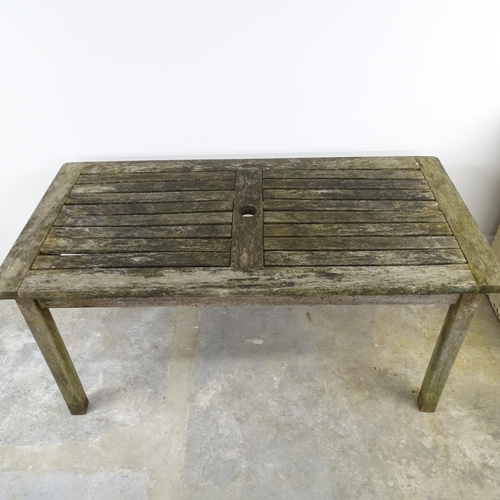 2592 - A weathered teak garden table. 152x73x76cm.