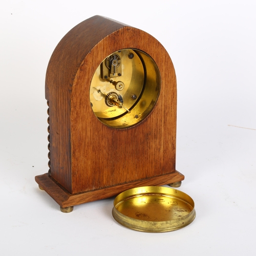 10 - An Edwardian oak lancet-top mantel clock, with French movement and enamel dial, H20cm