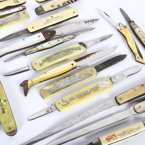 128 - A collection of ivorine and other handled advertising folding penknives and paper knives