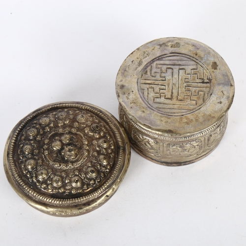 161 - An Oriental white metal circular box and cover, with allover embossed decoration, W7.5cm