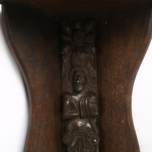 34 - An Antique carved oak figural panel, L55cm, mounted into a later oak corner bracket, overall length ... 