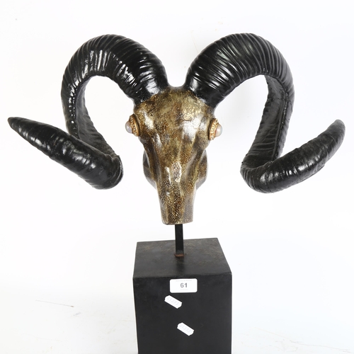 61 - A decorative composite ram's head and antlers, on plinth stand, overall height 56cm