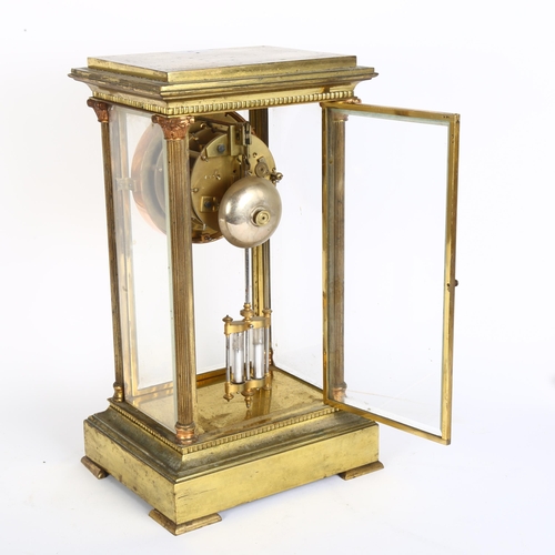 9 - A brass-cased 8-day 4-glass mantel clock, with white enamel dial, Roman numerals, and open escapemen... 