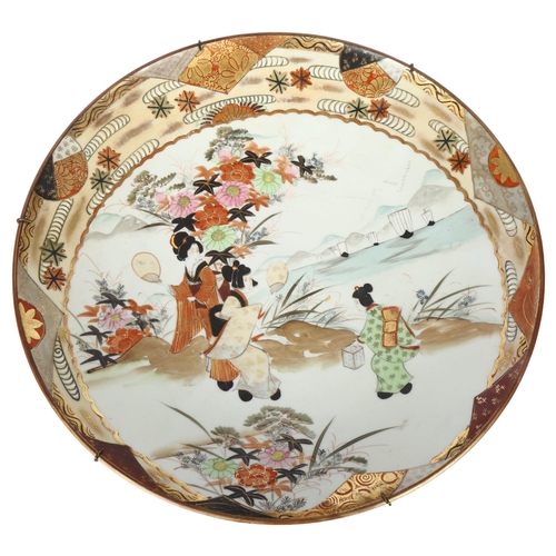 193 - A large Japanese Kutani shallow bowl, with painted and gilded decoration and character mark to the r... 