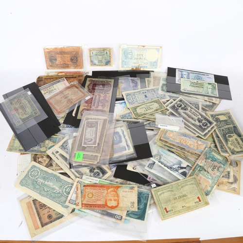 309 - A large quantity of world banknotes, including French 100 francs, 20 Hong Kong dollars, blue £5 note... 