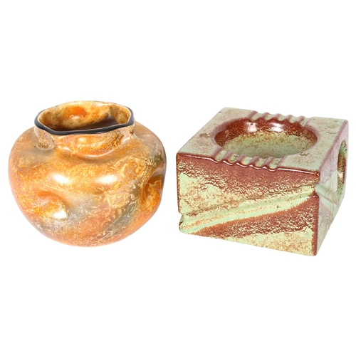 318 - An orange lustre glazed sack vase, H14cm, and a Studio pottery stylised emerald green ashtray (2)