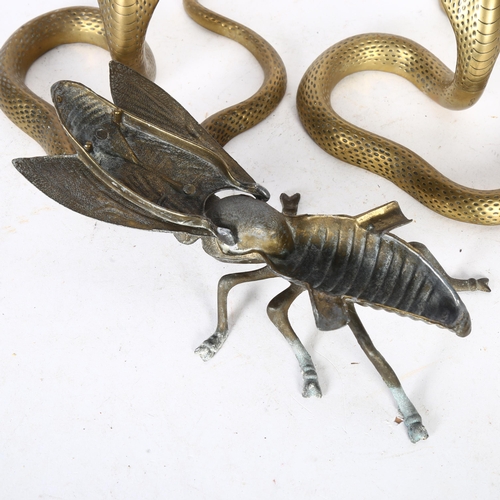 400 - A pair of brass cobra candlesticks, H21cm, and a fly figure ashtray