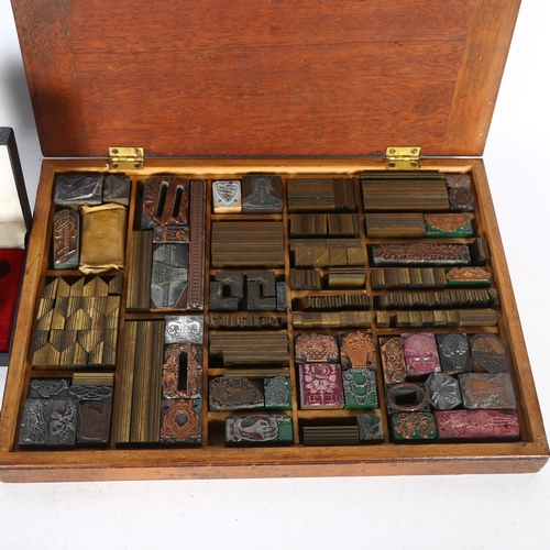 411 - A mahogany-cased collection of Vintage printing blocks, box length 33.5cm, and a Mylflam electric ci... 