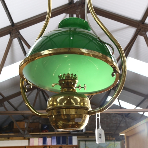 A brass oil lamp design ceiling light fitting, with green glass shade