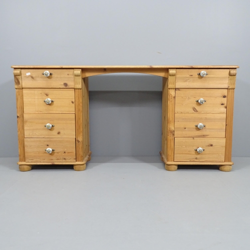 2194 - A modern pine kneehole desk / dressing table, having eight drawers with porcelain handles. Overall 1... 