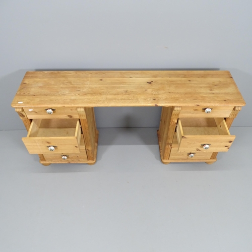 2194 - A modern pine kneehole desk / dressing table, having eight drawers with porcelain handles. Overall 1... 