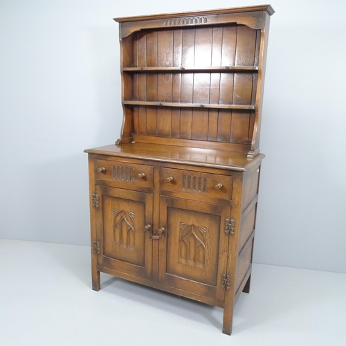 2200 - A reproduction oak two-section dresser, with carved decoration and label for Webber Furniture. 95x16... 