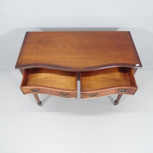 2205 - A reproduction crossbanded rosewood veneered writing desk of serpentine form, with 2 drawers on tape... 