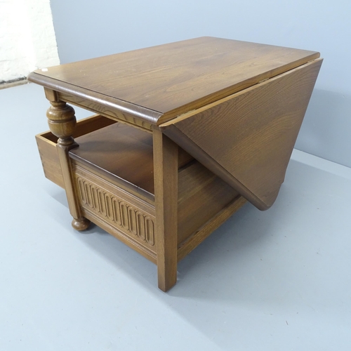 2208 - A mid-century Ercol drop-leaf coffee table, with single frieze drawer and carved linenfold decoratio... 