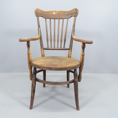 2219 - An early 20th century elm and beech circular seated elbow chair.