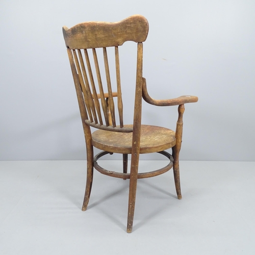 2219 - An early 20th century elm and beech circular seated elbow chair.