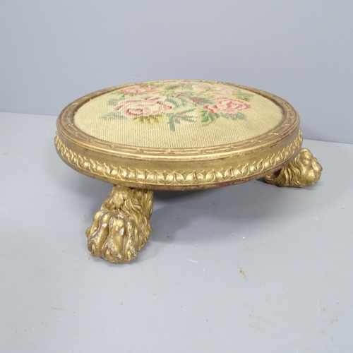 2230 - A Georgian tapestry-topped footstool, with gilded wood surround and lion paw feet, diameter approx 4... 