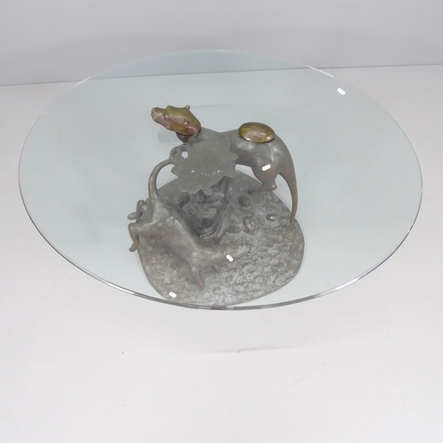 2241 - Mark Stoddart, a bronze otter design coffee table with oval glass top. 115x55x87cm.