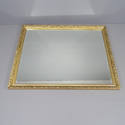 2256 - A modern gilt-framed wall mirror. 132x103cm