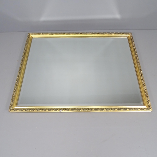 2257 - A modern gilt-framed wall mirror. 132x103cm