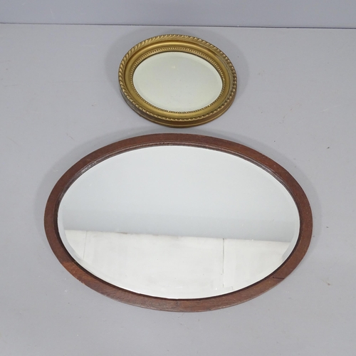 2264 - A gilt painted oval wall mirror, 31x26cm, and another oval wall mirror 64x44cm (2)