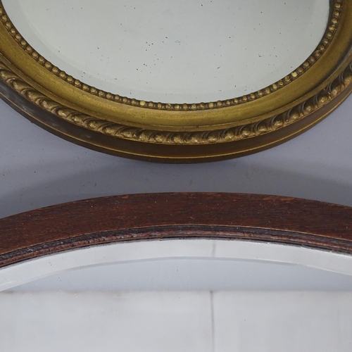 2264 - A gilt painted oval wall mirror, 31x26cm, and another oval wall mirror 64x44cm (2)