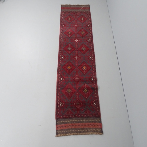 2267 - A red ground Meshwani runner. 252x57cm.