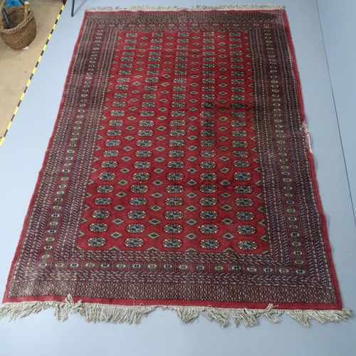 2283 - A red-ground Bokhara carpet. 280x190cm.