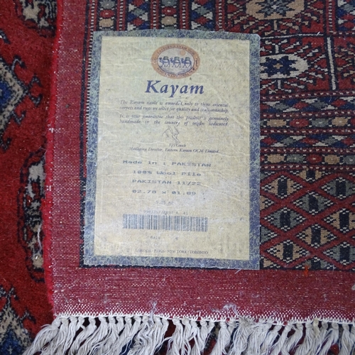 2283 - A red-ground Bokhara carpet. 280x190cm.