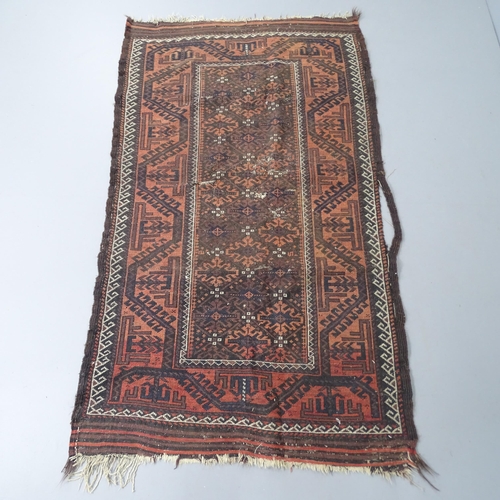 2284 - A salmon and brown ground Baluchi rug, 183x105cm.