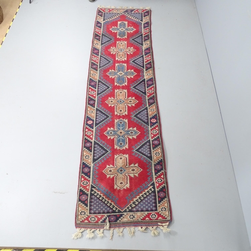 2285 - A red-ground Oushak runner. 280x73cm.