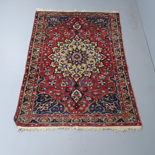 2304 - A red-ground Persian Sarouk rug. 202x138cm