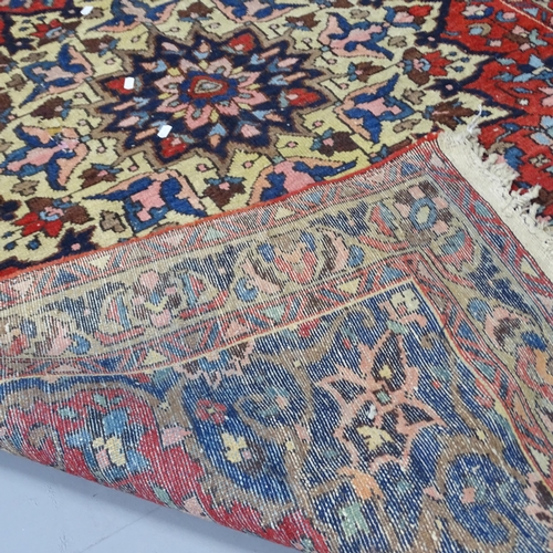 2304 - A red-ground Persian Sarouk rug. 202x138cm